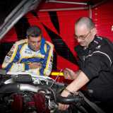Il pilota barese e un meccanico mentre controllano il motore prima di una competizione di rally a Casarano, nel leccese